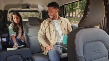 Vater sitz mit seiner Tochter in einem Dacia Fahrzeug