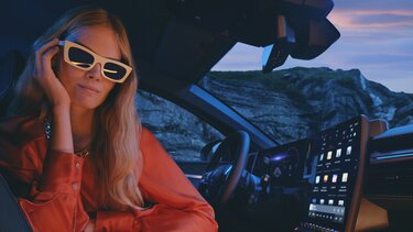 Megane E-tech interior image with woman wearing sunglasses